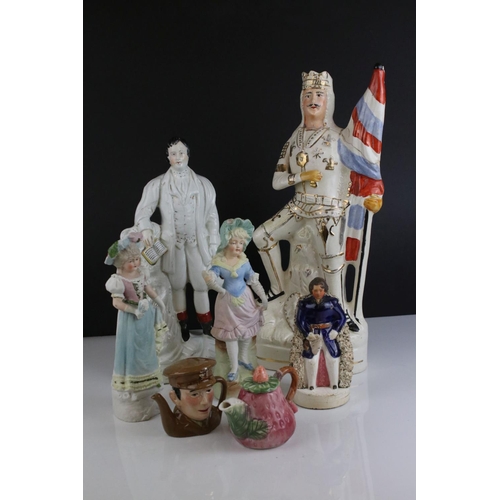 567 - A group of mixed ceramic figures to include two Staffordshire figures, together with two novelty tea... 