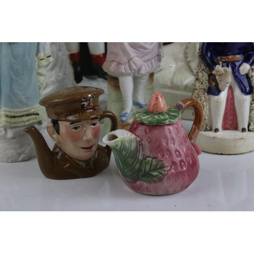 567 - A group of mixed ceramic figures to include two Staffordshire figures, together with two novelty tea... 