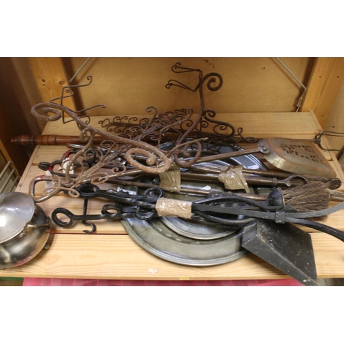 589 - A collection of fire side companion tools together with a group of pewter plates.