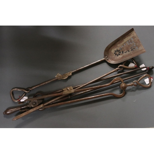 589 - A collection of fire side companion tools together with a group of pewter plates.