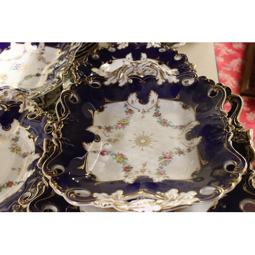 595 - A late 19th century blue and white ground part dinner service with floral swag decoration. Part of a... 