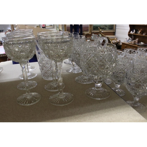 597 - A large quantity of good quality cut glass wine glasses,rummers jug etc.