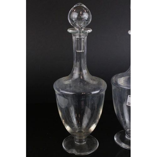 598 - A pair of antique baluster shaped glass decanters and three others without stoppers.