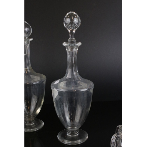 598 - A pair of antique baluster shaped glass decanters and three others without stoppers.