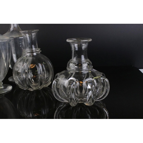 598 - A pair of antique baluster shaped glass decanters and three others without stoppers.