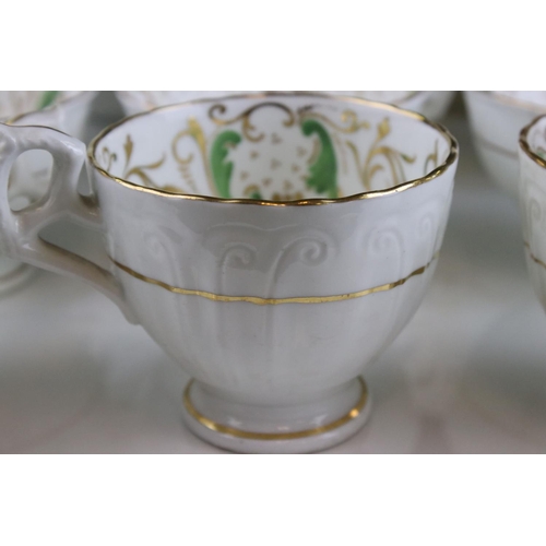 605 - An early 20th century white ground part tea set with swirling green and gilt decoration. Part of an ... 