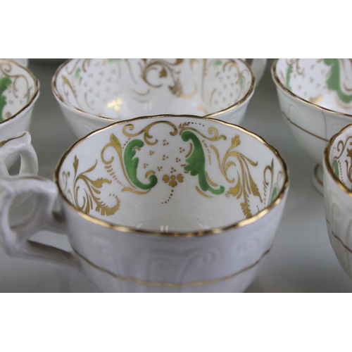 605 - An early 20th century white ground part tea set with swirling green and gilt decoration. Part of an ... 