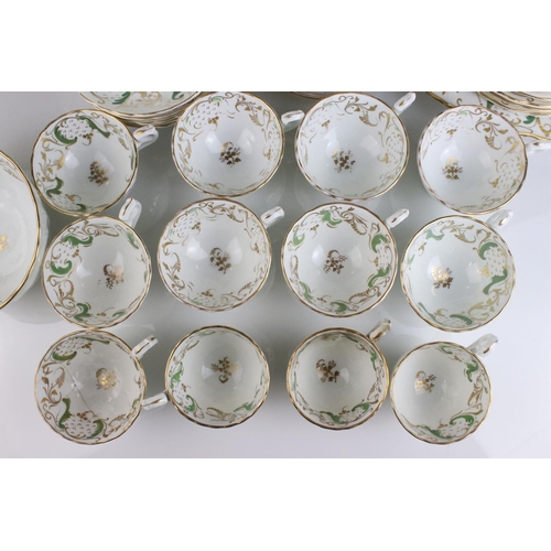 605 - An early 20th century white ground part tea set with swirling green and gilt decoration. Part of an ... 