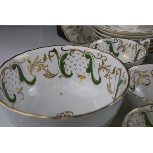 605 - An early 20th century white ground part tea set with swirling green and gilt decoration. Part of an ... 