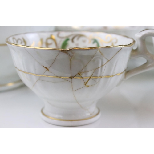 605 - An early 20th century white ground part tea set with swirling green and gilt decoration. Part of an ... 