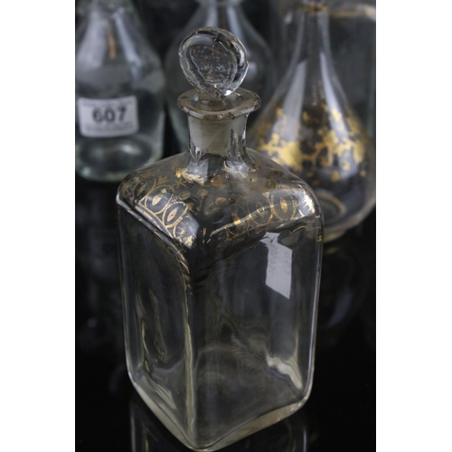 607 - A quantity of 19th century glass decanters some with etched and gilt decoration and a similar claret... 