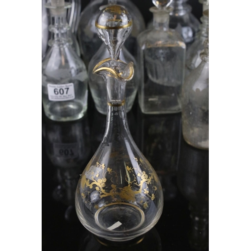 607 - A quantity of 19th century glass decanters some with etched and gilt decoration and a similar claret... 