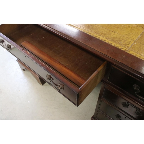 680 - George III style Mahogany twin pedestal desk with brown inset leather top and an arrangement of nine... 