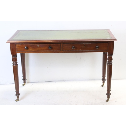 706 - Victorian mahogany writing table with two drawers, turned legs and castors, approx 117cm wide