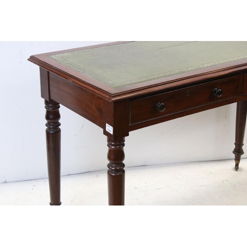 706 - Victorian mahogany writing table with two drawers, turned legs and castors, approx 117cm wide