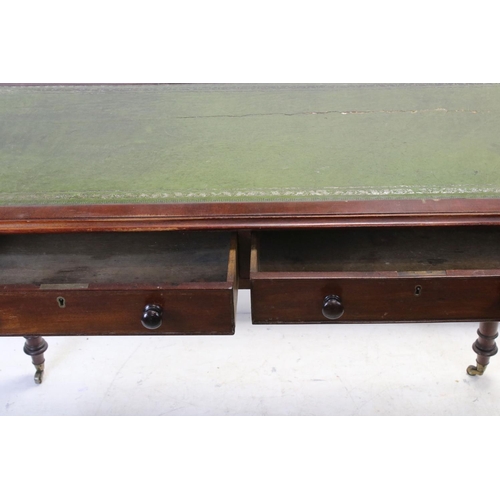 706 - Victorian mahogany writing table with two drawers, turned legs and castors, approx 117cm wide