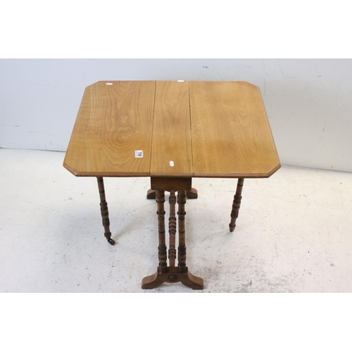 709 - 19th century Pale Walnut Sutherland Table raised on ringed turned supports, 60cms lopng x 61cms high