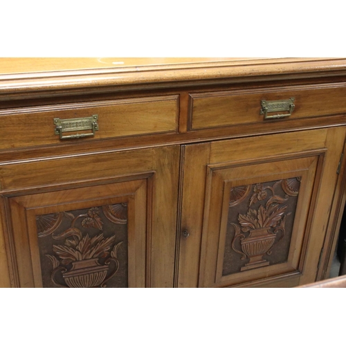 721 - Victorian Mahogany Sideboard with two drawers and two cupboard doors, the doors with panels carved w... 