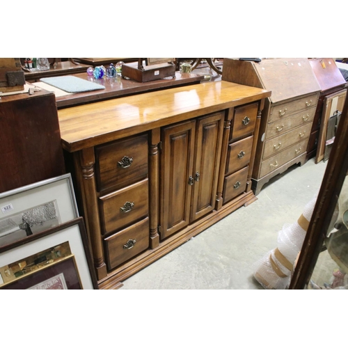 757 - Hardwood Sideboard with two cupboard doors flanked either side by a bank of three drawers, 150cms lo... 