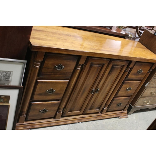 757 - Hardwood Sideboard with two cupboard doors flanked either side by a bank of three drawers, 150cms lo... 