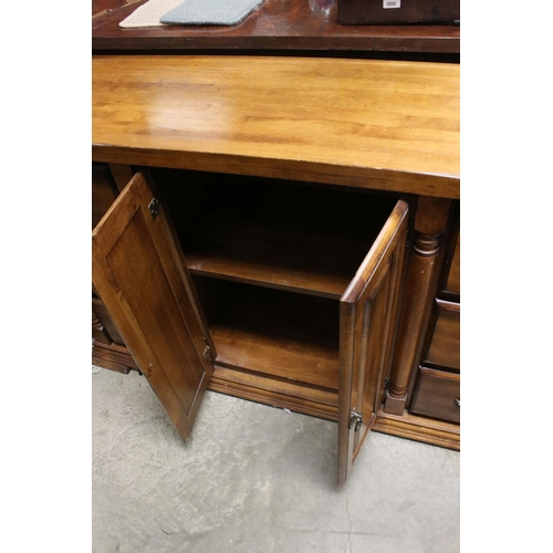 757 - Hardwood Sideboard with two cupboard doors flanked either side by a bank of three drawers, 150cms lo... 