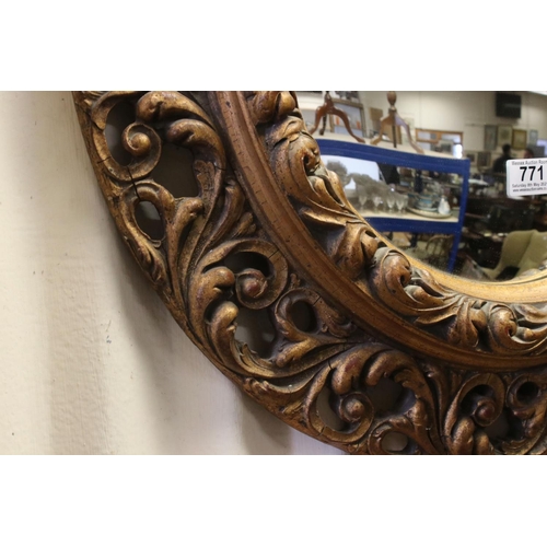 771 - 19th / Early 20th century Circular Mirror in a Gilt Scrolling Pierced Frame, 60cms diameter