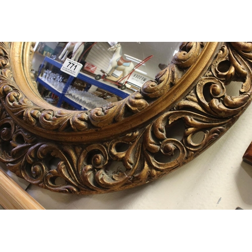 771 - 19th / Early 20th century Circular Mirror in a Gilt Scrolling Pierced Frame, 60cms diameter