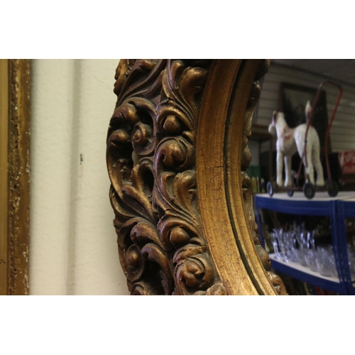 771 - 19th / Early 20th century Circular Mirror in a Gilt Scrolling Pierced Frame, 60cms diameter