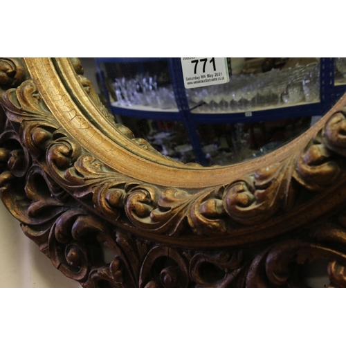 771 - 19th / Early 20th century Circular Mirror in a Gilt Scrolling Pierced Frame, 60cms diameter