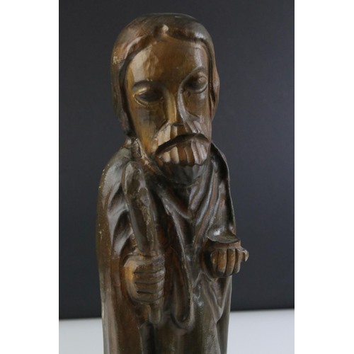 81 - A carved wooden figure of a religious figure.