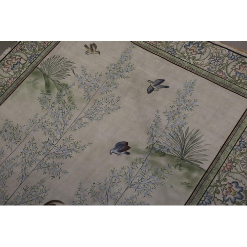 525 - A large hand painted oriental silk panel with decorative floral border.