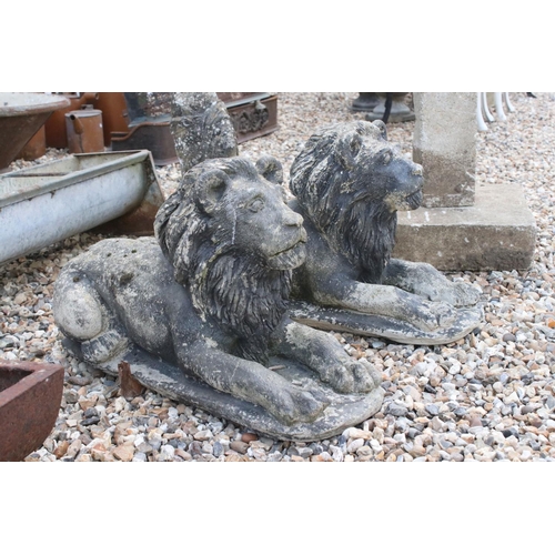 618 - A pair of vintage weathered lion statues, approx 58cm in length