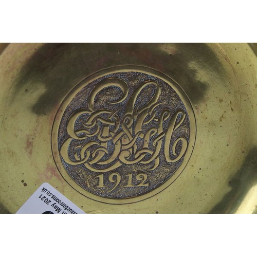 79 - An arts and Crafts early 20th century brass dish with stylized etched decoration to edge dated 1912 ... 