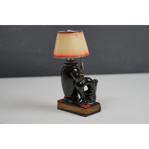 166 - A vintage ceramic table lighter in the form of a lamp with black cat.