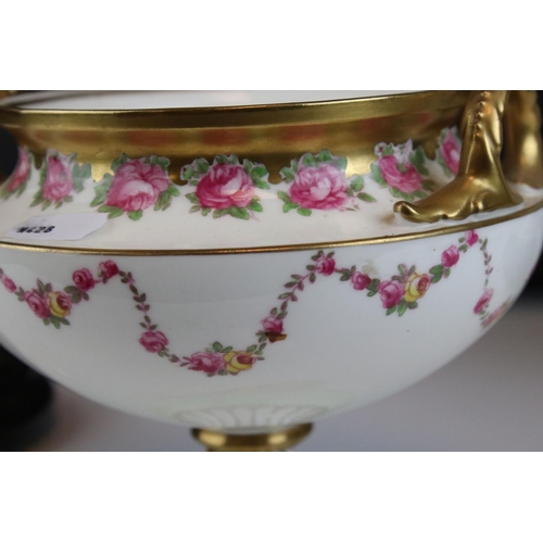 14 - Pair of Early 20th century Cauldon Ltd Twin Handled Urns, decorated with pink roses and with gilt hi... 