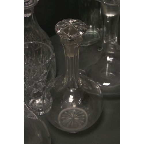 81 - A collection of glass jugs and decanters.