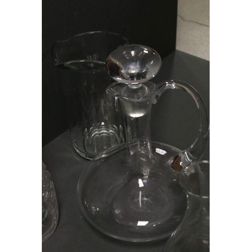 81 - A collection of glass jugs and decanters.