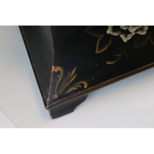 88 - A sarcophagus shaped black wooden box with hand painted decoration and velvet lined interior.