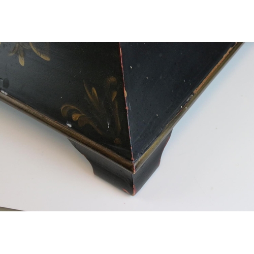 88 - A sarcophagus shaped black wooden box with hand painted decoration and velvet lined interior.