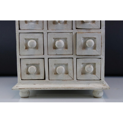 100 - A white tabletop chest of twelve drawers, stands approx 29cm in height.