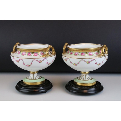 14 - Pair of Early 20th century Cauldon Ltd Twin Handled Urns, decorated with pink roses and with gilt hi... 