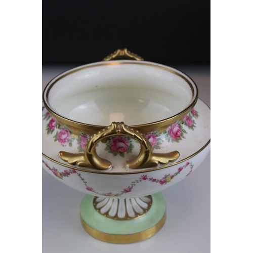 14 - Pair of Early 20th century Cauldon Ltd Twin Handled Urns, decorated with pink roses and with gilt hi... 