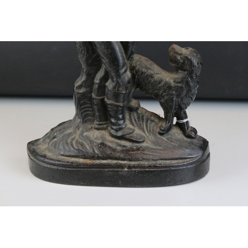 26 - Antique style Cast Iron Doorstop in the form of a Woodsman with Dog, 39cms high