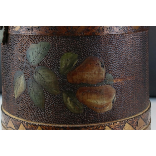 69 - An early 20th century lidded container with a handle, decorated with pokerwork and painted fruit. St... 