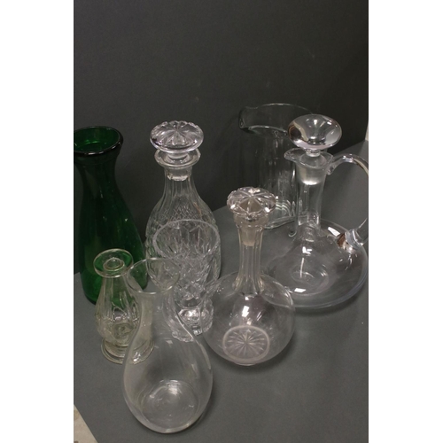 81 - A collection of glass jugs and decanters.