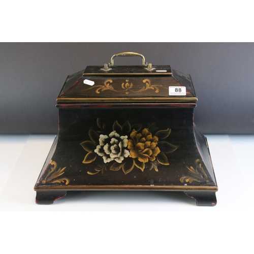 88 - A sarcophagus shaped black wooden box with hand painted decoration and velvet lined interior.