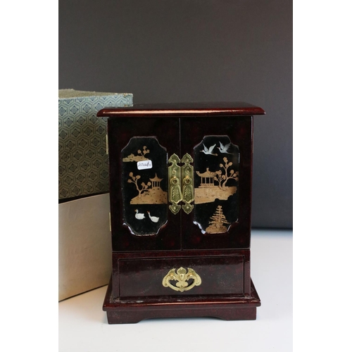 89 - Boxed lacquered Chinese single drawer, double door jewellery box with cork & stork diorama behind gl... 