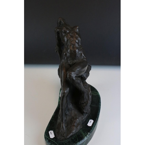 93 - Bronze figure of a nude woman reclining on a rock, on a green marble base