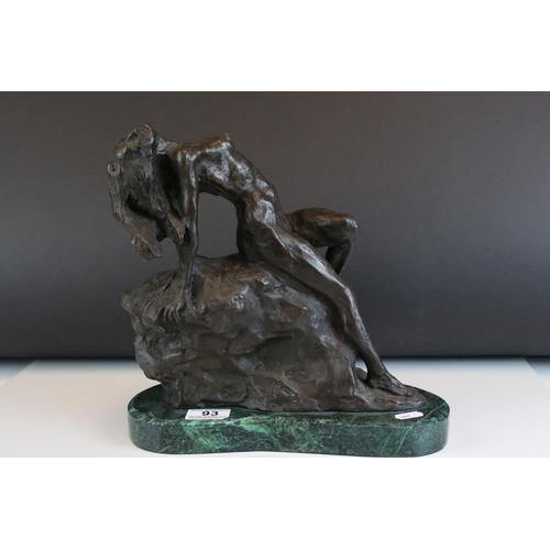 93 - Bronze figure of a nude woman reclining on a rock, on a green marble base