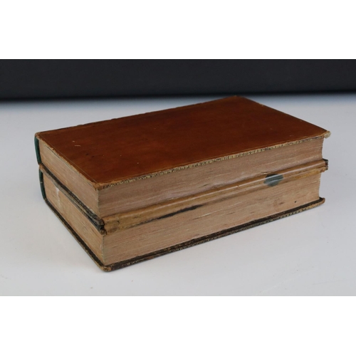 103 - Early 20th century double inkwell stand in the form of two leather bound antique books, 21cms wide